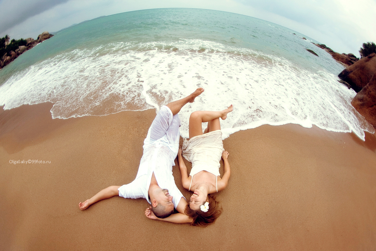 Wedding man and a woman lying on the beach