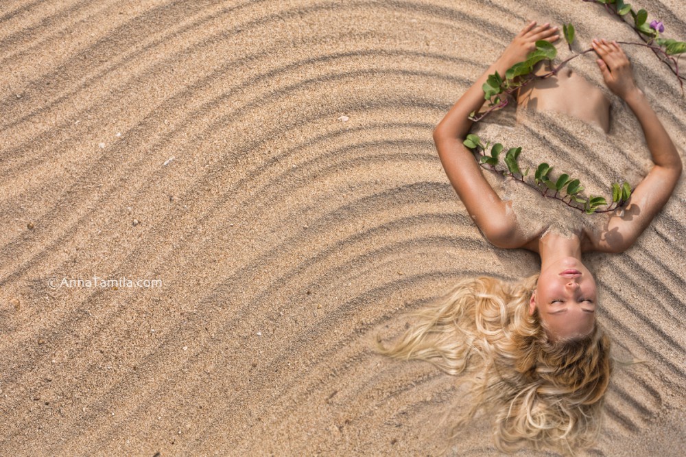 Fashion portrait of beautiful woman lying at the beach